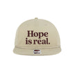 Beige cap with 'Hope is real.' text on a white background